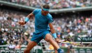Spain's Rafael Nadal plays a backhand return to Italy's Simone Bolelli during their men's singles first round match on day three of The Roland Garros 2018 French Open tennis tournament in Paris on May 29, 2018. (AFP / CHRISTOPHE SIMON)