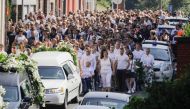 People attend on June 4, 2018 in Vottem near Liege, the funeral procession for Cyril Vangriecken, one of the three victims of a shooting the week before that prosecutors are treating as a terrorist attack. Belgium OUT / AFP / BELGA / THIERRY ROGE