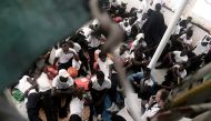 Migrants sit on the deck of the MV Aquarius, a search and rescue ship run in partnership between SOS Mediterranee and Medecins Sans Frontieres in the central Mediterranean Sea, June 12, 2018. Karpov / SOS Mediterranee/Handout via Reuters 