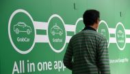 A man walk past the Grab transport office in Singapore on June 13, 2018. AFP / Roslan Rahman