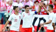 Poland's Robert Lewandowski (C), Dawid Kownacki (L) and Arkadiusz Milik react after Lewandowski scored a goal during the international friendly football match between Poland and Lithuania in Warsaw, Poland, on June 12, 2018. AFP / Janek Skarzynski