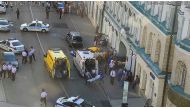 Police officers, investigators and members of emergency services work at the site of an accident after a taxi ran into a crowd of people in central Moscow, Russia June 16, 2018. Moscow Traffic Management Centre Press Service/Handout via Reuters 