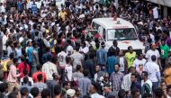 Ethiopians gather around an ambulance in Meskel Square in Addis Ababa on June 23, 2018, after an attack on a rally called by the Prime Minister Abiy Ahmed. AFP / YONAS TADESE
