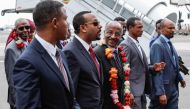 Eritrea's Foreign minister Osman Saleh Mohammed (3rdR) walks with Ethiopia's Prime Minister Abiy Ahmed (C) as Eritrea's delegation arrives for peace talks with Ethiopia at the international airport in Addis Ababa, Ethiopia, on June 26, 2018. / AFP / YONAS