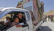 Syrian refugees arriving in their country from the eastern Lebanese border town of Arsal, drive through the crossing of al-Zamrani between the two countries on June 28, 2018.  AFP / Louai Beshara