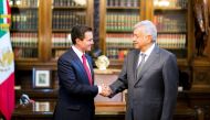 Mexico's President Enrique Pena Nieto and Mexico's president-elect Andres Manuel Lopez Obrador shake hands during a meeting at National Palace in Mexico City, Mexico in this handout photograph released to Reuters by the Mexico Presidency, July 3, 2018. Me