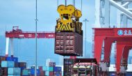 A container is transferred at a port in Qingdao in China's eastern Shandong province on July 6, 2018.  AFP