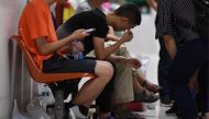 A Chinese relative cries at the Vachira phuket Hospital in phuket on July 8, 2018, after a tourist boat carrying 105 passengers, mostly Chinese tourists, capsized in rough seas on July 5.  / AFP / MOHD RASFAN
