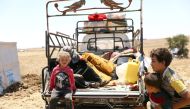 Internally displaced girl from Deraa province sits at a back of a truck near the Israeli-occupied Golan Heights in Quneitra, Syria July 11, 2018. Reuters/Alaa Al-Faqir