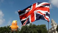 Demonstrators float a blimp portraying US President Donald Trump, next to a Union Flag above Parliament Square, during the visit by Trump and First Lady Melania Trump in London, Britain July 13, 2018. REUTERS/Peter Nicholls