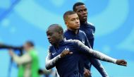 French midfielder N’Golo Kante (front), Kylian Mbappe (centre) and Paul Pogba warm up at the Saint Petersburg Stadium in Saint Petersburg in this file photo. 