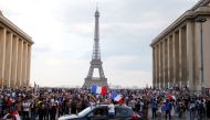 France fans celebrate in front of the Eiffel Tower after France win the World Cup. Reuters/Jean-Paul Pelissier
