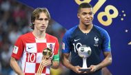 France's forward Kylian Mbappe (R) poses with the FIFA Young Player award beside Croatia's midfielder Luka Modric holding the adidas Golden Ball prize during the trophy ceremony at the end of the Russia 2018 World Cup final football match between France a