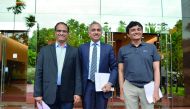Indian CEO and Managing Director of Infosys Salil Parekh (C), flanked by Chief Financial Officer M.D. Ranganath (R) and Chief Operating Officer U.B. Pravin Rao pose for a photograph in front of the Infosys headquarters prior to a press conference held in 