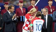 Croatia President Kolinda Grabar-Kitarovic speaks with Croatia's Luka Modric while President of France Emmanuel Macron looks on during the presentation REUTERS/Carl Recine 