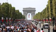 Crowds began converging early Monday on the Champs Elysees, the gathering point for all national celebrations, for a parade by the team atop an electric bus expected to start in the early evening.