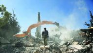 Palestinian Jihad Shawamrah stands on the ruins of his house that he demolished to not face the prospect of Israeli settlers moving in after he lost a land ownership case in Israeli courts, in the East Jerusalem neighbourhood of Beit Hanina, July 19, 2018