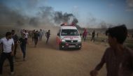 An ambulance takes a wounded to the hospital as as Israeli forces intervene to disperse Palestinians taking part in the 