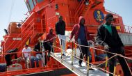 Migrants, intercepted aboard toy dinghies off the coast in the Strait of Gibraltar, leave a rescue boat after arriving at the port of Algeciras, southern Spain July 21, 2018. Reuters/Jon Nazca

