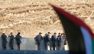 Israeli forces stand guard the area as Palestinians demonstrate in support of bedouin inhabitants near their village of Khan al-Ahmar, in the occupied West Bank July 18, 2018. (AFP / ABBAS MOMANI)