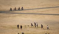 Visitors to Greenwich Park play football on the dry brown grass in London on July 23, 2018. AFP / Daniel Leal-Olivas