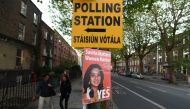 A Pro-Choice poster featuring Savita Halappanavar is placed near a sign for a polling station ahead of a 25th May referendum on abortion law in Dublin, May 23, 2018. (Reuters / Clodagh Kilcoyne) 