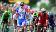 France's Arnaud Demare (L) celebrates as he crosses the finish line to win, ahead of France's Christophe Laporte (R) the 18th stage of the 105th edition of the Tour de France cycling race, on July 26, 2018 between Trie-sur-Baise and Pau, southwestern Fran