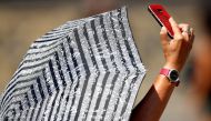 A faithful takes a selfie as she waits for Pope Francis to lead the Angelus prayer as temperature soars throughout the country at the Vatican August 5, 2018. Reuters/Max Rossi