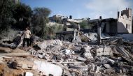 A Palestinian man inspects a site that was hit in an Israeli air strike, in Al-Mughraqa on the outskirts of Gaza City August 9, 2018. (REUTERS/Mohammed Salem)
