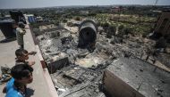 Palestinians inspect the wreckage of Al-Mughraqa municipality building after warplanes belonging to Israeli army carried out an airstrikes over residential areas in Gaza City, Gaza on August 9, 2018. (Ali Jadallah/Anadolu Agency) 