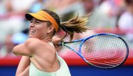 Maria Sharapova of Russia hits a return against Daria Kasatkina of Russia during day three of the Rogers Cup at IGA Stadium on August 8, 2018 in Montreal, Quebec, Canada. Minas Panagiotakis/Getty Images/AFP