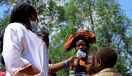 A Congolese health worker checks the temperature of a child before the launch of vaccination campaign against the deadly Ebola virus near Mangina village, near the town of Beni, in North Kivu province of the Democratic Republic of Congo, August 8, 2018. R
