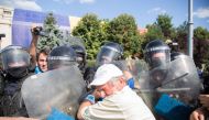 Riot police scuffles with a demonstrator during a protest in Bucharest, Romania August 10, 2018, in this image taken from social media. Picture taken August 10, 2018. Octav Dragan/via Reuters