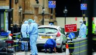Forensic investigators work at the site after a car crashed outside the Houses of Parliament in Westminster, London, Britain, August 14, 2018. Reuters/Henry Nicholls