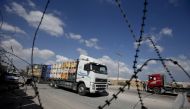 A truck carrying goods to Palestinians arrives at Kerem Shalom crossing in Rafah in the southern Gaza Strip on August 15, 2018. / AFP / SAID KHATIB 