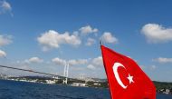 File photo of the Turkish flag is pictured on a boat with the Bosphorus bridge in the background in Istanbul, Turkey, August 6, 2016. REUTERS/Osman Orsal