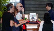 Relatives pray and pay their respects near the coffin of a victim of the Morandi bridge's collapse, in Genoa, on August 17, 2018. AFP / Marco Bertorello
 