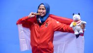 Indonesia's Defia Rosmaniar poses with her gold medal after defeating Iran's Marjan Salahshouri to win the taekwondo women's individual poomsae final at the 2018 Asian Games at Jakarta on August 19, 2018. / AFP / CHAIDEER MAHYUDDIN