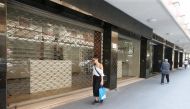 A woman walks past a closed shop in Beirut, Lebanon August 9, 2018. Picture taken August 9, 2018. REUTERS/Mohamed Azakir