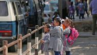 Pupils gather in front of a school run by the United Nations Agency for Palestinian Refugees (UNRWA) in Gaza City on August 29, 2018, on the first day of classes after the summer holidays.  AFP / Mahmud Hams
