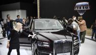Visitors inspect a sedan version of Russian President Vladimir Putin's new Argus Senat limousine at the Moscow International Motor Show in Moscow on August 29, 2018.  AFP / Alexander NEMENOV
