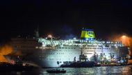 A firefighting vessel tries to extinguish a fire on the ferry Eleftherios Venizelos, at the port of Piraeus early in the morning, in Athens, on August 29, 2018.  AFP / Angelos Tzortzinis 

 
