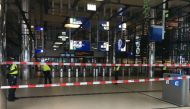Security officials stand alert at The Central Railway Station in Amsterdam on August 31, 2018, after two people were hurt in a stabbing incident. / AFP / Germain Moyon