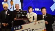 Japan's swimmer Ikee Rikako (2nd R), who won six gold medals during the games, poses for a photo with a cheque for 50,000 USD after being named as the 