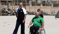 Iraqi paralympic weightlifter Thaer al-Ali (R) speaks to his trainer Tamer Ghanem, in the northern city of Mosul on August 25, 2018. AFP / Zaid AL-OBEIDI