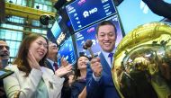 William Bin Lee, chief executive officer and chairman of electric car maker NIO, rings a ball as NIO stock begins trading on the floor of the opening bell at the New York Stock Exchange (NYSE), September 12, 2018 in New York City. The Shanghai-based elect