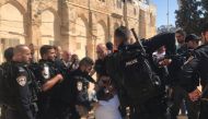 Israeli security forces take a Palestinian into custody as Israeli settlers storm Al-Aqsa compound in East Jerusalem on September 18, 2018. (Jerusalem Islamic Waqf/Anadolu Agency)