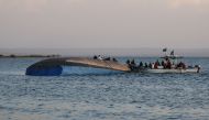 Investigators on boat work on the capsized ferry MV Nyerere which killed 131 people in Lake Victoria, Tanzania, on September 21, 2018.  AFP