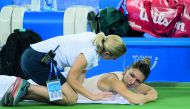 

 
Simona Halep (R) of Romania gets medical treatment as she plays against Dominika Cibulkova of Slovakia during their women's singles third round match of the WTA Wuhan Open tennis tournament in Wuhan on September 25, 2018. AFP / Nicolas Asfouri 

