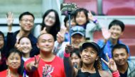 Naomi Osaka of Japan poses with fans after winning her women's singles third round match against Julia Goerges of Germany at the China Open tennis tournament in Beijing on October 4, 2018. AFP / Greg Baker


